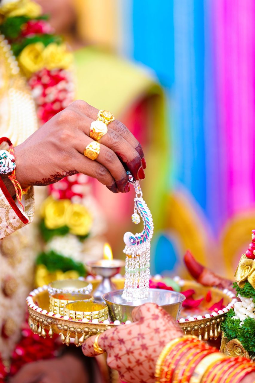 Cérémonie de mariage indienne réunissant les mariés et leurs familles autour d’un autel fleuri.